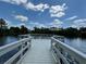 Wooden fishing pier extending over a calm lake at 3011 Marble Crest Dr, Land O Lakes, FL 34638