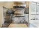 Outdoor kitchen with built-in grill and mini-fridge at 3011 Marble Crest Dr, Land O Lakes, FL 34638