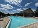 Community swimming pool with a large sundeck at 3011 Marble Crest Dr, Land O Lakes, FL 34638