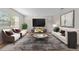 Living room features neutral colors, comfy seating, and a large TV at 304 S Habana Ave # A3, Tampa, FL 33609