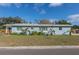 Ranch style home with light blue exterior, landscaping, and a spacious yard at 3046 35Th N Ave, St Petersburg, FL 33713