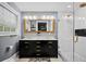 Elegant bathroom with double vanity, gold fixtures, and white subway tile shower at 319 26Th W St, Bradenton, FL 34205