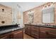 Bathroom with double vanity, dark brown cabinets, and a brick shower at 319 26Th W St, Bradenton, FL 34205
