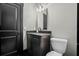 Modern powder room with dark vanity and matte black fixtures at 319 26Th W St, Bradenton, FL 34205