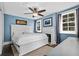 Bright bedroom with white bed frame, fireplace, and blue walls at 319 26Th W St, Bradenton, FL 34205