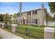 Two-story house with black fence, manicured lawn, and a brick driveway at 319 26Th W St, Bradenton, FL 34205