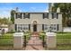 Two-story house with black fence, manicured lawn, and a brick walkway at 319 26Th W St, Bradenton, FL 34205