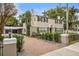 Two-story house with brick driveway, black fence, and manicured lawn at 319 26Th W St, Bradenton, FL 34205