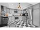 Modern kitchen with gray cabinets, checkerboard floor, and stainless steel appliances at 319 26Th W St, Bradenton, FL 34205