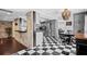 Modern kitchen with gray cabinets, checkerboard floor, and stainless steel appliances at 319 26Th W St, Bradenton, FL 34205