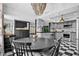 Modern kitchen with gray cabinets, checkerboard floor, and stainless steel appliances at 319 26Th W St, Bradenton, FL 34205