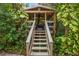 Relaxing outdoor patio with wooden stairs leading up to a covered seating area at 319 26Th W St, Bradenton, FL 34205