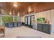 Large screened porch with comfortable seating and a mini-fridge at 319 26Th W St, Bradenton, FL 34205