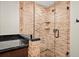 Large walk-in shower with brick walls and glass enclosure at 319 26Th W St, Bradenton, FL 34205