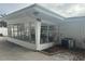 Sunroom addition with many windows, white exterior and A/C unit at 3553 Center Cir, Largo, FL 33774