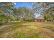 Large backyard with fountain and mature oak trees at 3704 Berger Rd, Lutz, FL 33548