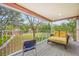 Relaxing balcony overlooking a lush backyard with patio furniture at 3704 Berger Rd, Lutz, FL 33548