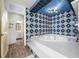 Spa-like bathroom with a large jacuzzi tub and blue tile at 3704 Berger Rd, Lutz, FL 33548