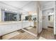 Double vanity bathroom with a large mirror and white cabinets at 3704 Berger Rd, Lutz, FL 33548