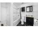 Clean bathroom with a bathtub, toilet, and dark vanity at 3704 Berger Rd, Lutz, FL 33548