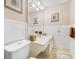 Clean bathroom with updated vanity and tiled walls at 3704 Berger Rd, Lutz, FL 33548