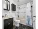 Clean bathroom with dark vanity, tub and shower at 3704 Berger Rd, Lutz, FL 33548