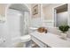 Bathroom with shower/tub combo, updated vanity, and tiled walls at 3704 Berger Rd, Lutz, FL 33548