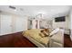 Main bedroom with hardwood floors and access to balcony at 3704 Berger Rd, Lutz, FL 33548