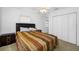 Bright bedroom with a double bed, large closet, and neutral decor at 3704 Berger Rd, Lutz, FL 33548