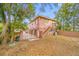 View of the house's side elevation, showcasing a charming two-story building with a gated entrance at 3704 Berger Rd, Lutz, FL 33548
