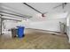 Spacious garage featuring tiled floors and overhead storage at 3704 Berger Rd, Lutz, FL 33548