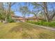 Side view of house showcasing landscaping and walkway at 3704 Berger Rd, Lutz, FL 33548