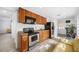 Stainless steel appliances and wood cabinets in this galley kitchen at 3704 Berger Rd, Lutz, FL 33548