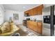 Wood cabinets, stainless steel appliances and adjacent sitting area at 3704 Berger Rd, Lutz, FL 33548