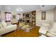 Spacious living room featuring a brick fireplace and hardwood floors at 3704 Berger Rd, Lutz, FL 33548