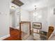 Upstairs hallway with hardwood floors and chandelier at 3704 Berger Rd, Lutz, FL 33548