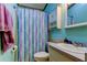 Cozy bathroom featuring a shower with stylish curtain and vanity with built-in storage at 3841 Julie Dr, Wesley Chapel, FL 33543