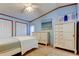 Bright bedroom with ample closet space and soft blue walls is perfect for relaxation at 3841 Julie Dr, Wesley Chapel, FL 33543