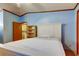 Light blue bedroom with carpet, laundry room and closet access, and shelving unit at 3841 Julie Dr, Wesley Chapel, FL 33543
