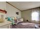 Cozy secondary bedroom with natural light is a flexible space, and the colorful decor adds a touch of whimsy at 3841 Julie Dr, Wesley Chapel, FL 33543