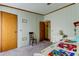 Carpeted bedroom with closet, dresser and doorway access at 3841 Julie Dr, Wesley Chapel, FL 33543