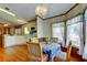 Dining area with a chandelier next to the kitchen, wood floors, and natural light at 3841 Julie Dr, Wesley Chapel, FL 33543