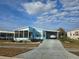 Light blue single-wide manufactured home with carport and screened porch at 3841 Julie Dr, Wesley Chapel, FL 33543