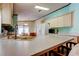 Bright kitchen with stainless steel appliances, light wood cabinets and a view into the dining area at 3841 Julie Dr, Wesley Chapel, FL 33543
