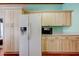 Bright kitchen featuring a new refrigerator and light wood cabinetry providing ample storage at 3841 Julie Dr, Wesley Chapel, FL 33543