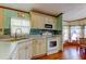 Well-lit kitchen with stainless steel appliances, light wood cabinetry, and a decorative backsplash at 3841 Julie Dr, Wesley Chapel, FL 33543