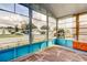 Bright and airy lanai with large windows offering neighborhood views and a starfish patterned rug at 3841 Julie Dr, Wesley Chapel, FL 33543