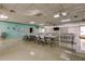 Spacious meeting room provides tables, chairs, and a screen for presentations at 3841 Julie Dr, Wesley Chapel, FL 33543