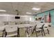 Spacious meeting room provides tables, chairs, and a screen for presentations at 3841 Julie Dr, Wesley Chapel, FL 33543