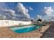 Outdoor pool featuring a brick perimeter, gated surround, and sunny skies at 3841 Julie Dr, Wesley Chapel, FL 33543